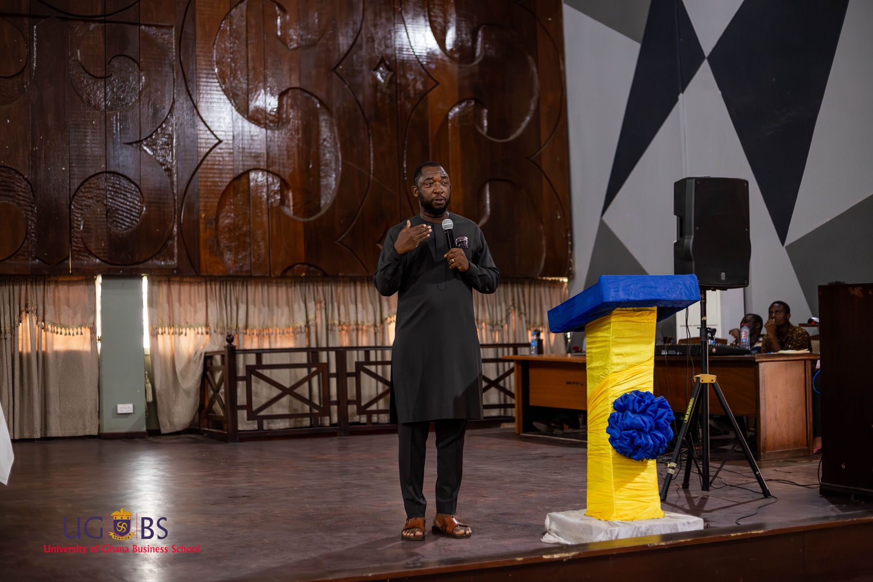 Addressing students from the stage